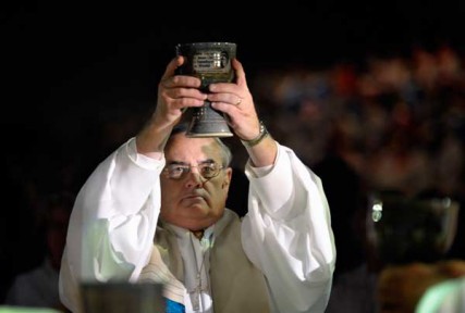 Bishop Larry M. Goodpaster lifts a chalice high during the consecration of the elements in the April 24 opening worship service of the 2012 United Methodist General Conference in Tampa, Florida. RNS photo courtesy Paul Jeffrey/United Methodist News Service 