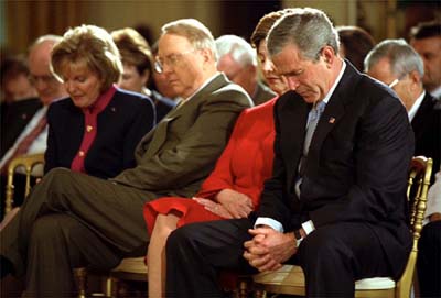 President Bush and wife Laura bow their heads along with National Day of Prayer Chairwoman Shirley Dobson and her husband, religious broadcaster James Dobson, at a May 2003 ceremony in the East Room of the White House. President Obama has said he will appeal a federal judge's ruling that the law creating the National Day of Prayer is unconstitutional, even though he declined to host a Bush-style observance at the White House. RNS file photo/The White House 