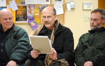 John Hancock (center) reads blogs posts from a Spokane man who chose suicide over cancer treatment. 