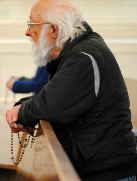 A man prays at The Cathedral of Our Lady of Lourdes after a new pope is elected. 