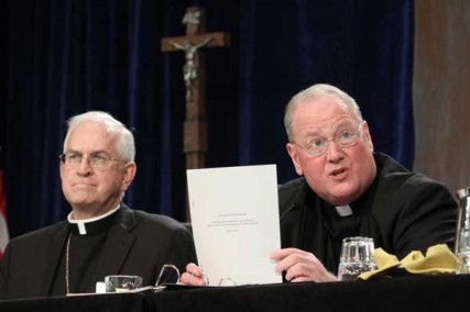 New York Cardinal Timothy M. Dolan, president of the U.S. Conference of Catholic Bishops, addresses the bishops at their annual mid-year meeting June 13, 2012 in Atlanta. At left is Archbishop Joseph E. Kurtz of Louisville, Ky., vice president of the conference.  