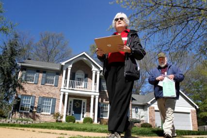 Marty Scrima, (left) and Jim Wedick, members of the Holy Infant Catholic Church evangelization team, work the New Ballwin Estates subdivision in Ellisville on Saturday, April 20, 2013, going door to door, re-welcoming registered members to restart an active membership at the church and taking suggestions on how to make worship better. 