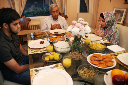 mran, 22, and his parents Habeeb and Seemi Ahmed pray in their Long Island, NY home just before breaking their fast after the first day of Ramadan on Aug. 11, 2010 