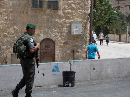 A young IDF soldier patrolling Shuhada St in Hebron  