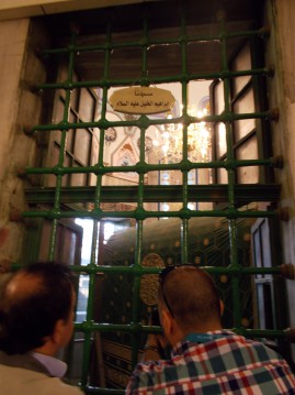 Peeking in to see Abraham from the Muslim side of the Tomb of the Patriarchs 