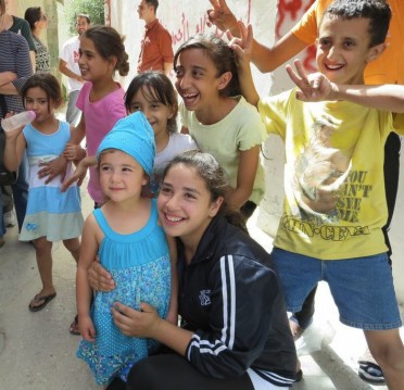 Children greeting our youngest delegate, Viola, in Dheisheh Refugee Camp 