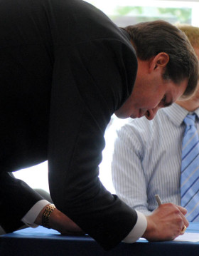 Gonzaga President Thayne McCulloh signs the St. Francis Pledge to Care.