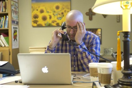 At Millwood Presbyterian Church, the Rev. Craig Goodwin forgets his diagnosis of lymphoma for a moment and prays over the phone with a parishioner experiencing a family crisis on Oct. 22.