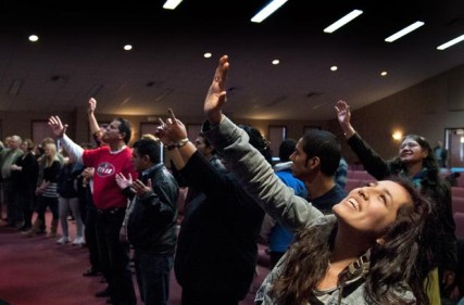 Abi Lopez gives praise during the Church of God of Prophecy’s Spanish service at the Intersection building in Spokane Valley. Photo by Dan Pelle/Spokesman-Review