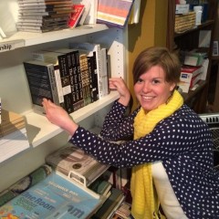 Book Parlor Board Member Cara Strickland prepares the "SpokaneFAVS shelf"/Contributed