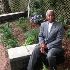 The Rev. Anthony Thompson, pastor of Holy Trinity Reformed Episcopal in Charleston, S.C., in a garden planted at his church in honor of his wife, Myra Thompson. A reverend herself and a congregant at Emanuel African Methodist Episcopal Church in Charleston, she died in the massacre at Bible study at Emanuel on June 17, 2015. Photo courtesy of the Rev. Anthony Thompson