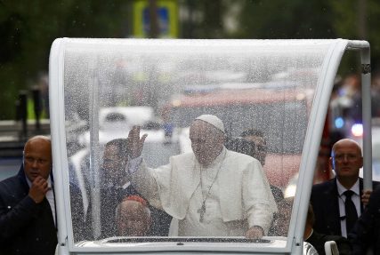 Pope Francis waves at the faithfuls as he travels in the popemobile with Cardinal Stanislaw Dziwisz, Archbishop of Krakow (L) to a welcoming ceremony at Wawel Royal Castle in Krakow, Poland July 27, 2016.  REUTERS/Kacper Pempel