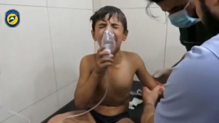 A still image taken on September 7, 2016 from a video posted on social media said to be shot in Aleppo's Al Sukari on September 6, 2016, shows a boy breathing with an oxygen mask inside a hospital, after a suspected chlorine gas attack, Syria. Social Media via Reuters/File Photo