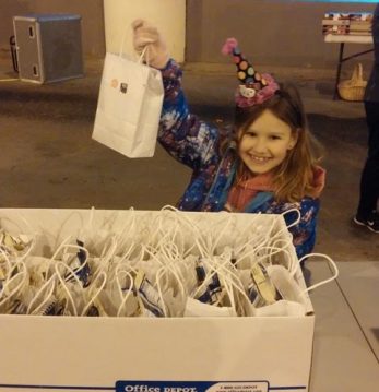 Handing out goodie bags at Blessings Under the Bridge